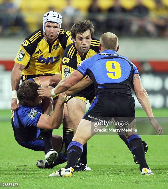 Conrad Smith of the Hurricanes faces Brett Sheehan of the Force during the round two Super 14 match between the Hurricanes and the Western Force at...