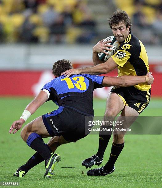 Conrad Smith of the Hurricanes is tackled by Mitchell Inman of the Force during the round two Super 14 match between the Hurricanes and the Western...
