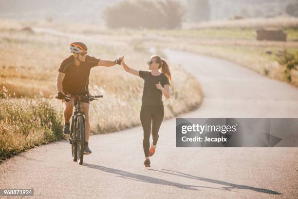 friends running - 2018 cycling stock pictures, royalty-free photos & images