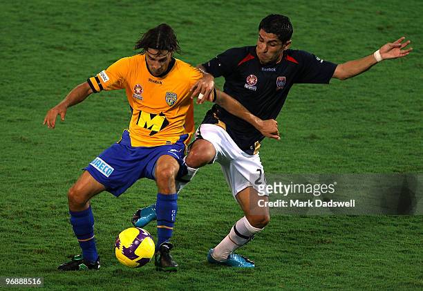 Zenon Caravella of United holds off Labinot Haliti of the Jets during the A-League semi final match between Gold Coast United and the Newcastle Jets...