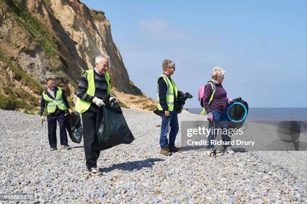 People Picking Up Litter On Beach Photos And Premium High Res Pictures people-picking-up-litter-on-beach-photos-and-premium-high-res-pictures