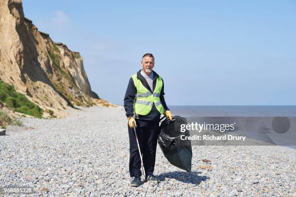portrait of volunteer beach cleaner - beach clean up uk stock pictures, royalty-free photos & images
