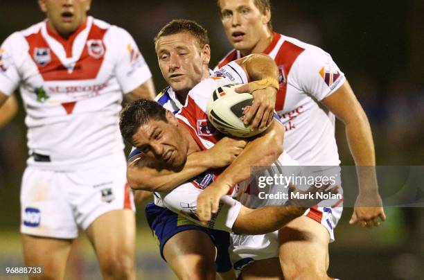 Blake Green of the Bulldogs tackles Luke Pridis of Dragons during the NRL trial match between the St George Illawarra Dragons and the Canterbury...