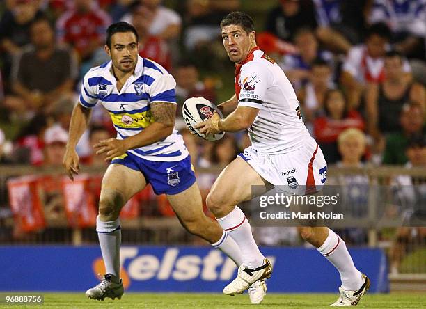 Luke Pridis of the Bulldogs runs the ball as Dean Halatau defends during the NRL trial match between the St George Illawarra Dragons and the...