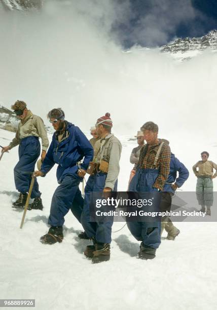 Edmund Hillary roped to Tenzing Norgay returning to Camp IV, after their successful ascent of Everest, surrounded by other team members, Nepal, 30th...