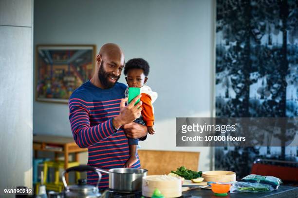 Man with baby son (6-11 months) at home