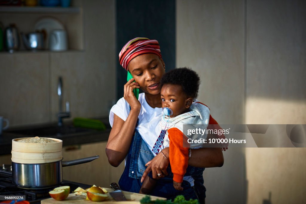 Woman with baby son in kitchen