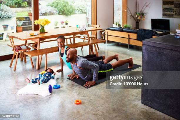 baby boy with parents practicing yoga - family yoga stock pictures, royalty-free photos & images