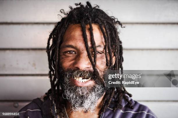 man with dreadlocks smiles - long black hair stock pictures, royalty-free photos & images