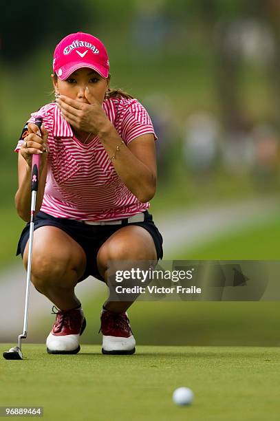 Momoko Ueda of Japan lines up a putt on the 5th green during round three of the Honda PTT LPGA Thailand at Siam Country Club on February 20, 2010 in...