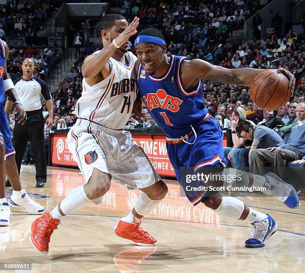 Daniel Gibson of the Cleveland Cavaliers drives against D. J. Augustin of the Charlotte Bobcats on February 19, 2010 at the Time Warner Cable Arena...