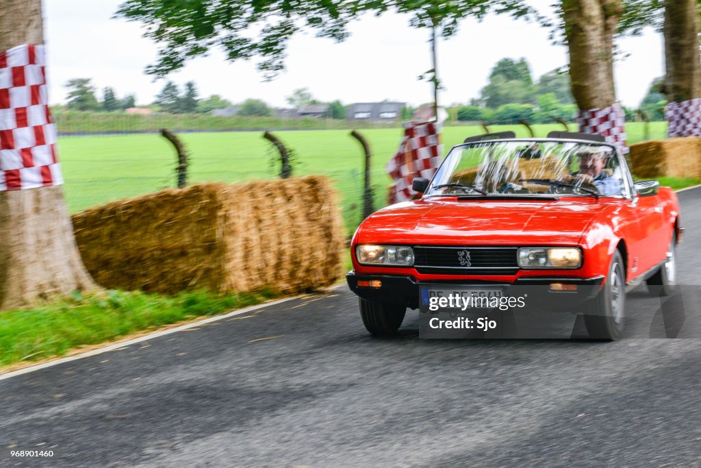Peugeot 504 Convertible classic car driving on a country road