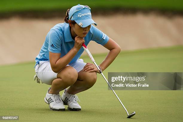 Shinobu Moromizato of Japan lines up a putt on the 8th green during round three of the Honda PTT LPGA Thailand at Siam Country Club on February 20,...
