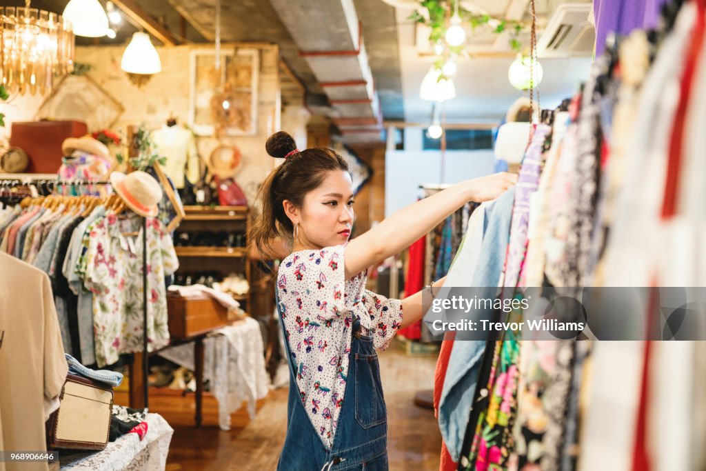 Young woman shopping in a vintage clothing store