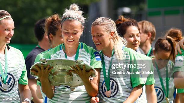 Zsanett Jakabfi and Lara Dickenmann of Wolfsburg celebrate the champion chip after the Allianz Frauen Bundesliga match between VfL Wolfsburg and 1....