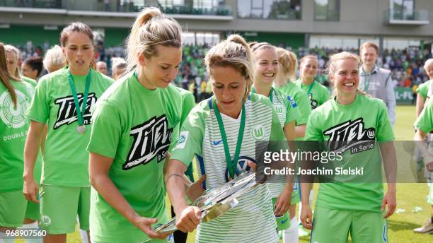 Lena Goessling and Anna Blaesse of Wolfsburg celebrate the champion chip after the Allianz Frauen Bundesliga match between VfL Wolfsburg and 1. FC...