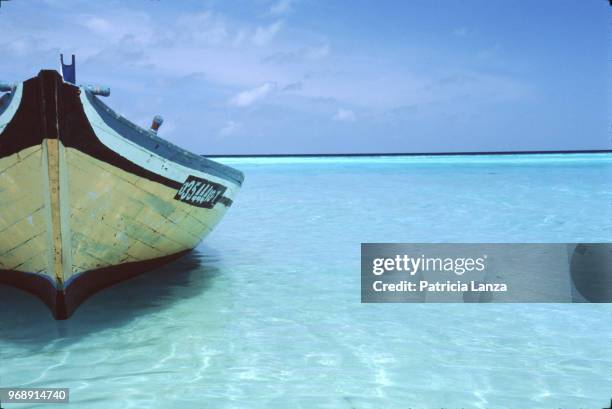 View of a wooden boat in shallow water, Maldives, 2003.