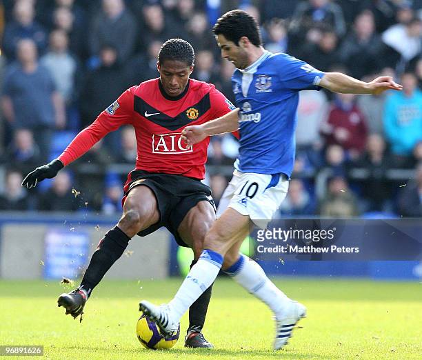 Antonio Valencia of Manchester United clashes with Mikel Arteta of Everton during the FA Barclays Premier League match between Everton and Manchester...