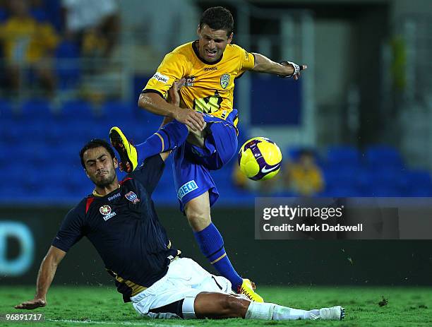 Jason Culina of United has a shot at goal over Tarek Elrich of the Jets during the A-League semi final match between Gold Coast United and the...