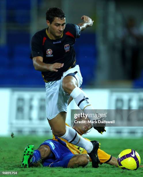 Zenon Caravella of United attempts to tackle Adam D'Apuzzo of the Jets during the A-League semi final match between Gold Coast United and the...