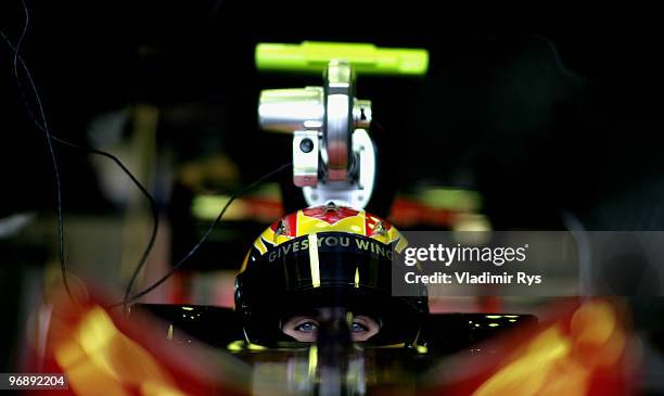 Jaime Alguersuari of Spain and Scuderia Toro Rosso sits in his car in the garage during winter testing at the Circuito De Jerez on February 19, 2010...