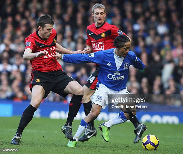 Michael Carrick of Manchester United clashes with Steven Pienaar of Everton during the FA Barclays Premier League match between Everton and...