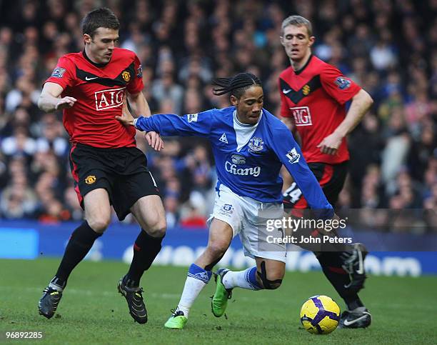 Michael Carrick of Manchester United clashes with Steven Pienaar of Everton during the FA Barclays Premier League match between Everton and...