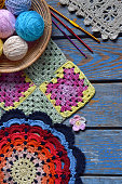 Equipment for knitting and crochet hook, olorful rainbow cotton yarn, ball of threads, wool, knitted elements, napkin . Granny square. Handmade crocheting crafts. DIY concept. Copy space