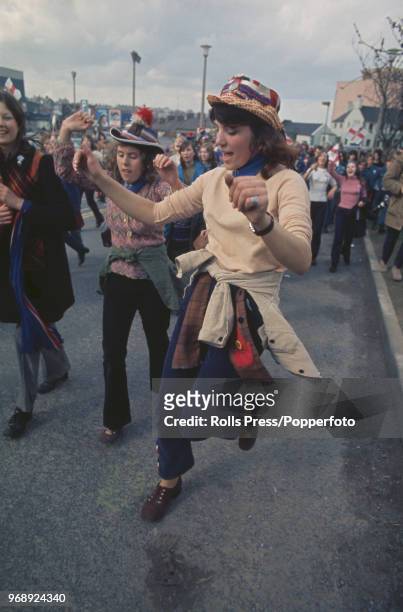 View of young women, wearing red, white and blue hats, celebrating as they take part in a junior Orange Order Easter Parade in Bangor, County Down,...