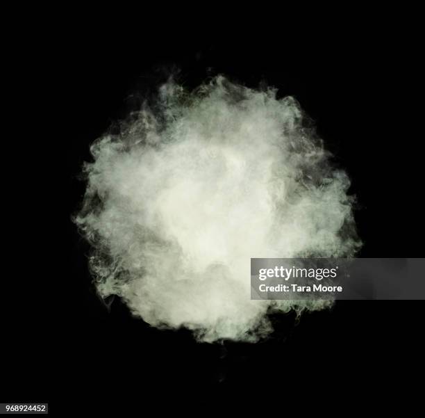 puff of white smoke on black background - cumulus stockfoto's en -beelden