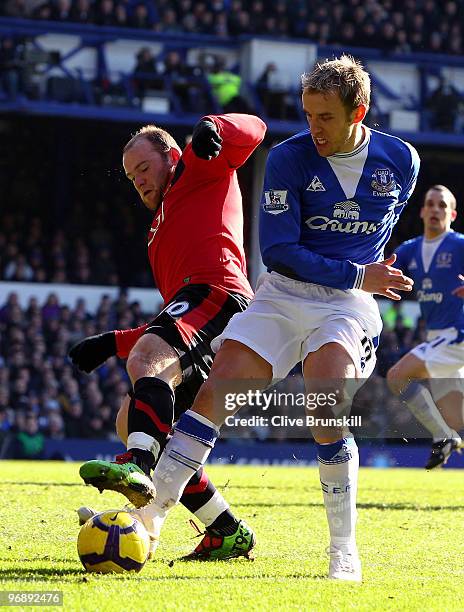 Wayne Rooney of Manchester United clashes with Phil Neville of Everton during the Barclays Premier League match between Everton and Manchester United...