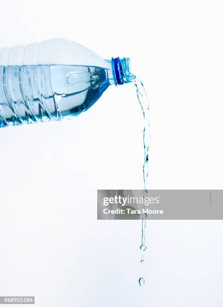 plastic bottle pouring water - gießen wasser stock-fotos und bilder