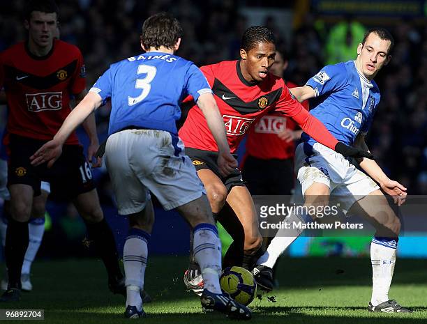 Antonio Valencia of Manchester United clashes with Leighton Baines and Leon Osman of Everton during the FA Barclays Premier League match between...