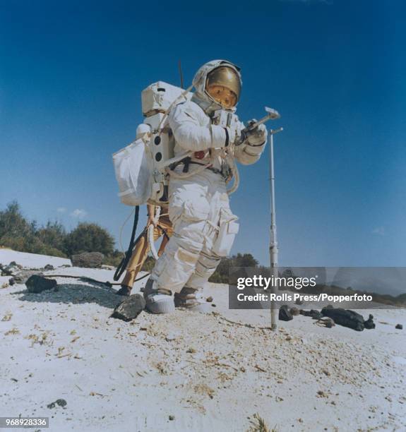 American astronaut and Mission Commander of the Apollo 16 manned mission to the Moon, John Young , wearing a full space suit, carries out a...