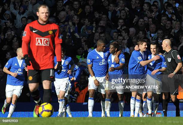 Everton's English midfielder Dan Gosling celebrates with team-mates after scoring Everton's second goal during the English Premier League football...