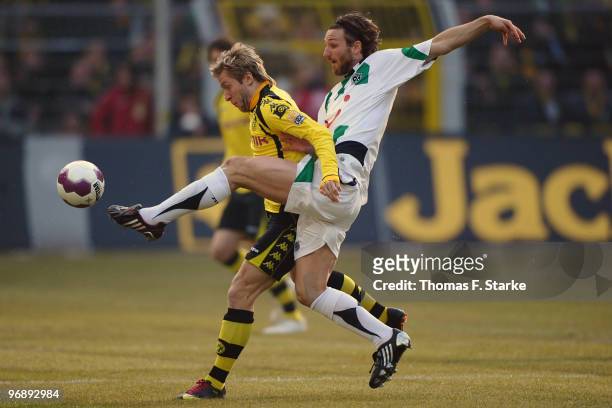 Christian Schulz of Hannover tackles Jakub 'Kuba' Blaszczykowski of Dortmund during the Bundesliga match between Borussia Dortmund and Hannover 96 at...