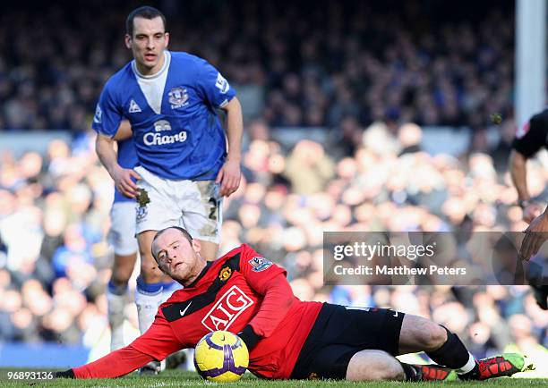 Wayne Rooney of Manchester United clashes with Leon Osman of Everton during the FA Barclays Premier League match between Everton and Manchester...