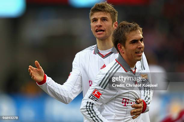 Thomas Mueller of Bayern celebrates scoring his team's first goal with team mate Philipp Lahm during the Bundesliga match between 1. FC Nuernberg and...