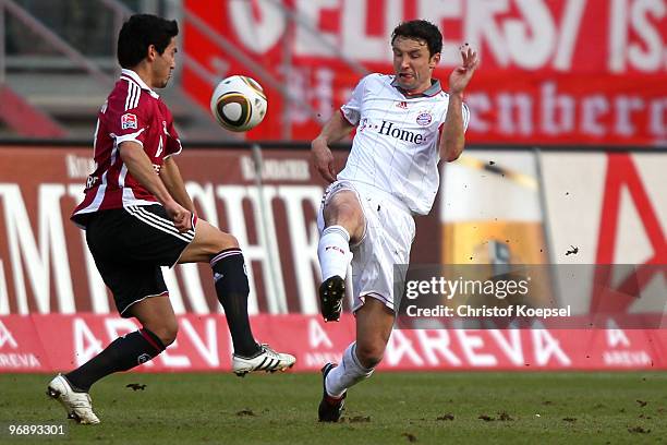 Ilkay Guendogan of Nuernberg battles for the ball with Mark van Bommel of Bayern during the Bundesliga match between 1. FC Nuernberg and FC Bayern...