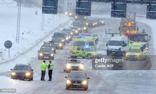 Damaged cars are pictured on the E4 road in Stockholm following heavy snowfalls and strong winds on February 20, 2010. Heavy snow took drivers in...