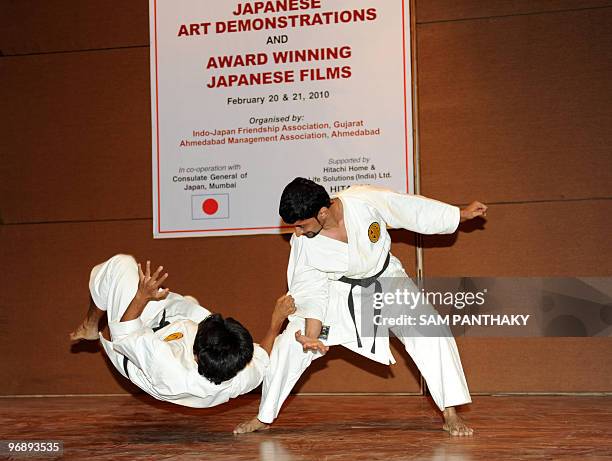 Martial artists perform during a demonstration in Ahmedabad on February 20, 2010. Some six members demonstrated martial arts on the first day of the...