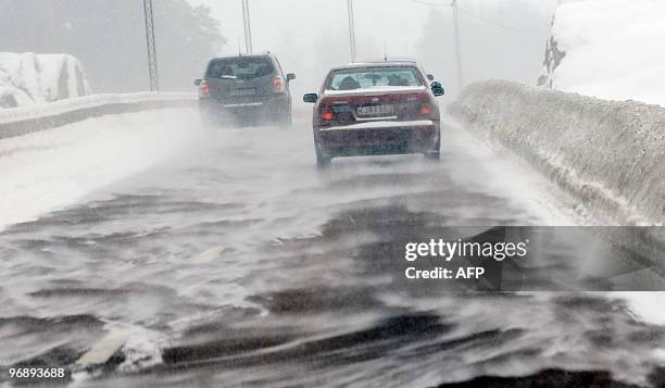 Cars drive in snowdrift on the the Kymlingelanken road in Stockholm following heavy snowfalls and strong winds on February 20, 2010. Heavy snow took...