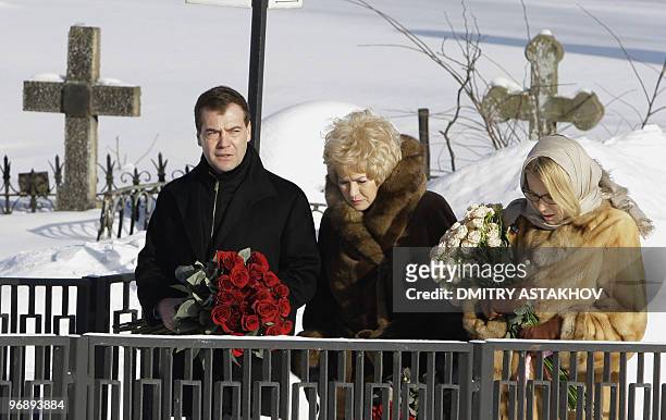 Russian President Dmitry Medvedev carries flowers to lay them to the tomb of Anatoly Sobchak in St. Petersburg on February 20 marking 10th...
