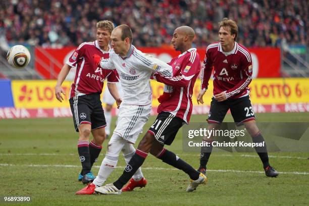 Mike Frantz of Nuernberg and Mickael Tavares of Nuernberg challenge Arjen Robben of Bayern during the Bundesliga match between 1. FC Nuernberg and FC...