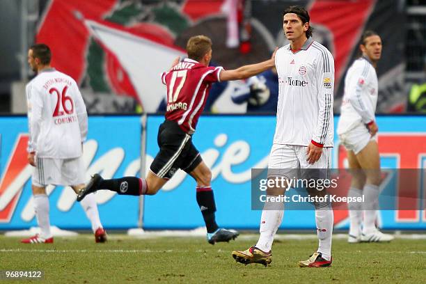 Mike Frantz of Nuernberg celebrates his team's first goal and Diego Contento , Mario Gomez and Martin Demichelis of Bayern look dejected during the...