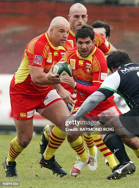 Perpignan's wing Farid Sid runs with the ball in front of Montauban's hooker Brice Mach during their French Top 14 rugby union match Montauban vs...