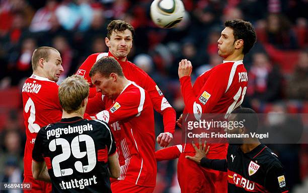 Miso Brecko, Lukas Podolski, Milivoje Novakovic and Kevin Pezzoni of Koeln jump during the Bundesliga match between 1. FC Koeln and VfB Stuttgart at...