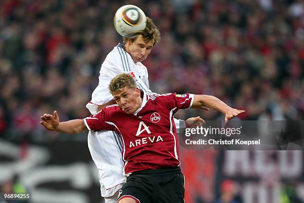 Holger Badstuber of Bayern and Mike Frantz of Nuernberg jump for a header during the Bundesliga match between 1. FC Nuernberg and FC Bayern Muenchen...