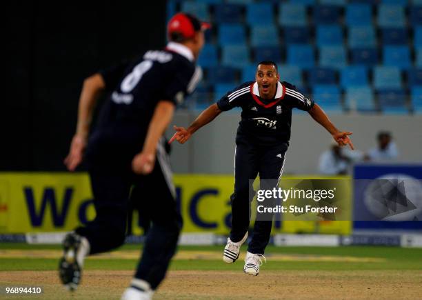 England bowler Ajmal Shahzad celebrates as Stuart Broad catches after Pakistan batsman Imran Farhat, his second wicket in his first over in...