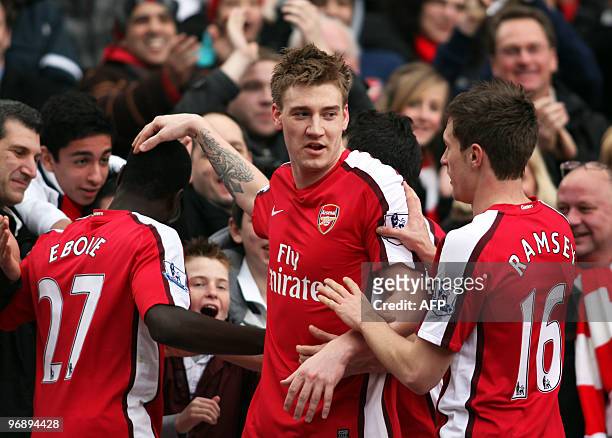 Arsenal's Danish striker Nicklas Bendtner celebrates scoring the opening goal with Ivorian team-mate Emmanuel Eboue and Welsh midfielder Aaron Ramsey...